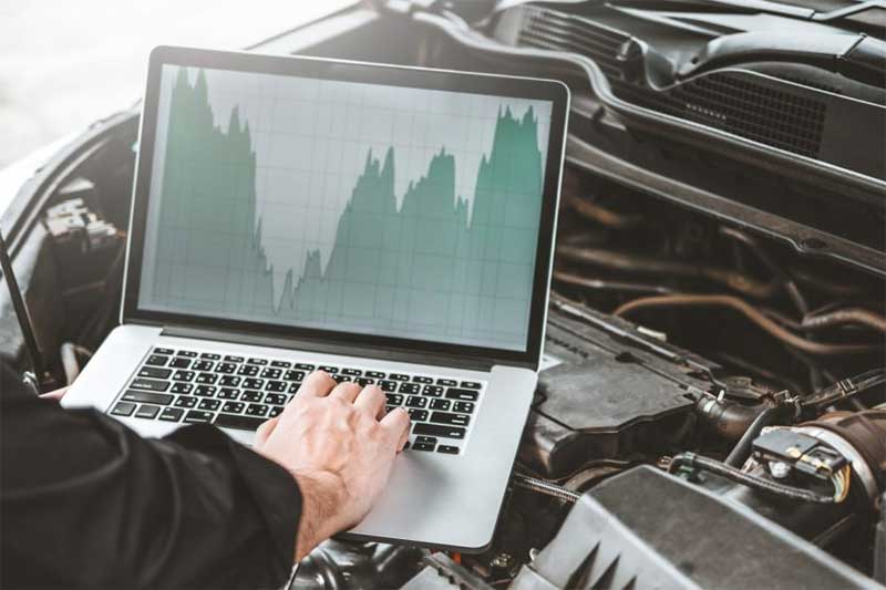 A technician at Independent Vehicles in Timperley, Altrincham is running diagnostics on a car engine