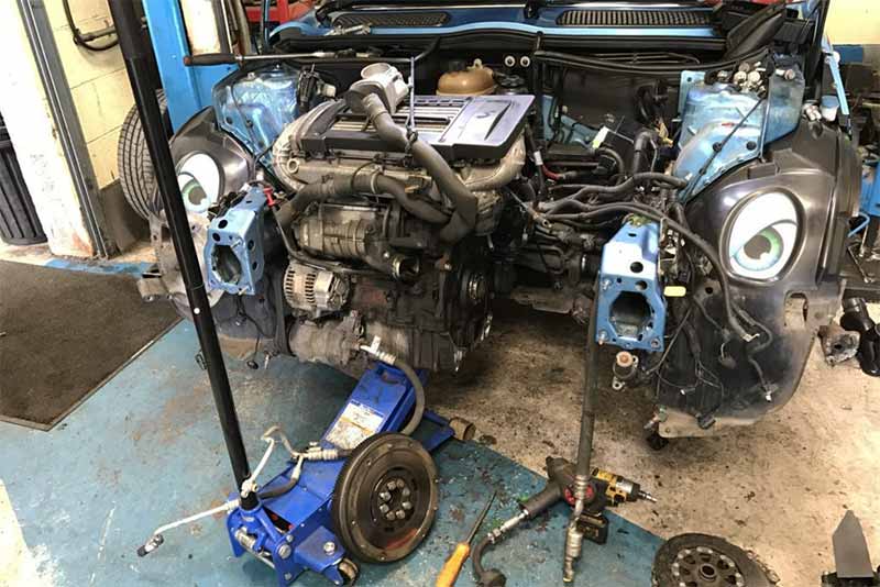 A mini with the engine being rebuilt at Independent Vehicles in Manchester